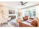 Cozy living room with modern furnishings, brick accent wall, and sliding glass door to the backyard at 7925 Putting Green Way, Reunion, FL 34747