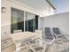Outdoor patio with a table, chairs and lounge chairs at 7925 Putting Green Way, Reunion, FL 34747