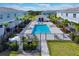 Aerial view of a community pool featuring lounge areas and well-maintained landscaping at 7925 Putting Green Way, Reunion, FL 34747