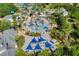 A waterpark features a splash pad, surrounded by sunbathing areas and lush landscaping at 7925 Putting Green Way, Reunion, FL 34747