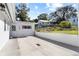 An impressive backyard featuring a modern concrete design, with a partial view of the neighboring yard at 814 S Lakeshore Blvd, Lake Wales, FL 33853