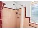 Classic bathroom featuring a shower with vintage fixtures and a window with natural light at 814 S Lakeshore Blvd, Lake Wales, FL 33853