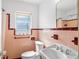 Quaint bathroom with a vintage sink, toilet, and window at 814 S Lakeshore Blvd, Lake Wales, FL 33853