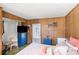 Bedroom featuring wood paneled walls, a blue dresser, and ample natural light at 814 S Lakeshore Blvd, Lake Wales, FL 33853
