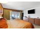 Bedroom with a queen bed, large television, and lanai access at 814 S Lakeshore Blvd, Lake Wales, FL 33853