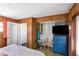 Bedroom featuring wood paneling, a blue dresser, and a closet for storage at 814 S Lakeshore Blvd, Lake Wales, FL 33853