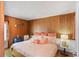 Cozy bedroom with wood paneling, comfortable bedding, and ample natural light at 814 S Lakeshore Blvd, Lake Wales, FL 33853