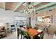 Stylish dining room with a modern light fixture, wood paneling, and seamless access to the kitchen at 814 S Lakeshore Blvd, Lake Wales, FL 33853