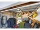 A peek into the garage, revealing a tidy space with a sitting area and yard equipment, including a grill at 814 S Lakeshore Blvd, Lake Wales, FL 33853