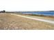 Serene view of the lake from a grassy area with a walking path at 814 S Lakeshore Blvd, Lake Wales, FL 33853