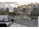 Relaxing balcony overlooking a tennis court and scenic landscape at 8148 Tibet Butler Dr, Windermere, FL 34786