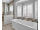 Bathroom with freestanding soaking tub and window at 8148 Tibet Butler Dr, Windermere, FL 34786