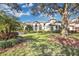 Spacious home with a large front yard, mature trees, and lush landscaping at 8148 Tibet Butler Dr, Windermere, FL 34786