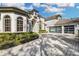 Well-maintained home with a large driveway and lush landscaping at 8148 Tibet Butler Dr, Windermere, FL 34786