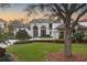 Beautiful home with a large tree in front and a spacious lawn at 8148 Tibet Butler Dr, Windermere, FL 34786