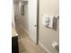 Hallway leading to bathroom with granite countertop vanity and tile floor at 8189 Roseville Rd, Davenport, FL 33896