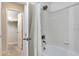 Bright bathroom with tiled walls, shower, and open closet at 8189 Roseville Rd, Davenport, FL 33896