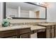 Bathroom vanity features double sinks with granite countertops and dark wood cabinets at 8189 Roseville Rd, Davenport, FL 33896