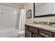 Bathroom features tub, granite countertop vanity, and tiled floor at 8189 Roseville Rd, Davenport, FL 33896
