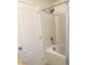 Bathtub/shower combo with white tile and a shower curtain in a bright bathroom at 8189 Roseville Rd, Davenport, FL 33896