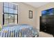 Comfortable bedroom with striped bedding, chest of drawers, and bright window at 8189 Roseville Rd, Davenport, FL 33896