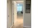 Open doorway reveals a cozy bedroom with natural light from a window and a comfortable chair at 8189 Roseville Rd, Davenport, FL 33896
