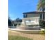 Community fountain featuring decorative tile and landscaping against a backdrop of buildings at 8189 Roseville Rd, Davenport, FL 33896