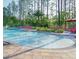 Large community pool with lounge chairs and an umbrella shaded table area at 8189 Roseville Rd, Davenport, FL 33896