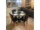 A dining area features seating for four and is adjacent to a large sectional couch at 8189 Roseville Rd, Davenport, FL 33896