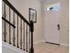 Front entryway showcasing dark, ornate banister, and a white front door with tiled flooring at 8189 Roseville Rd, Davenport, FL 33896