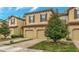 Charming two-story townhome with a terracotta roof, attached garage, and landscaped front yard at 8189 Roseville Rd, Davenport, FL 33896