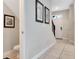 Inviting hallway with neutral walls, tile flooring, and staircase to the upper level at 8189 Roseville Rd, Davenport, FL 33896