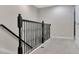 Upstairs hallway showcasing black decorative railing and white trim details at 8189 Roseville Rd, Davenport, FL 33896