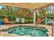 Relaxing hot tub area with patio chairs and a serene outdoor setting at 8189 Roseville Rd, Davenport, FL 33896