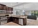 Open kitchen leading to the living room, featuring stainless steel appliances and granite countertops at 8189 Roseville Rd, Davenport, FL 33896