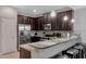 Well-equipped kitchen featuring stainless steel appliances, granite countertops, and dark wood cabinets at 8189 Roseville Rd, Davenport, FL 33896