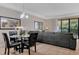 Bright living room featuring a glass table and a large gray sectional couch with sliding glass doors at 8189 Roseville Rd, Davenport, FL 33896
