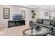 Spacious living room features a gray sectional couch, entertainment center, and neutral decor at 8189 Roseville Rd, Davenport, FL 33896