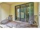 Outdoor patio includes metal chaise lounge chairs and a sliding glass door at 8189 Roseville Rd, Davenport, FL 33896
