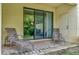 Relax on this outdoor patio with metal chaise lounge chairs and a sliding glass door at 8189 Roseville Rd, Davenport, FL 33896