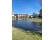 Scenic view of a community pond with a fountain and well-maintained landscaping at 8189 Roseville Rd, Davenport, FL 33896