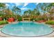 Beautiful pool area with a pergola, lounge chairs, umbrellas, and lush landscaping for ultimate relaxation at 8189 Roseville Rd, Davenport, FL 33896