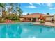 Inviting community pool with plenty of seating and lush landscaping on a bright, sunny day at 8189 Roseville Rd, Davenport, FL 33896