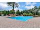 Inviting pool area with a lush tropical setting, comfortable lounge chairs, and palm trees at 8189 Roseville Rd, Davenport, FL 33896