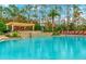 Relaxing pool area with a pergola, lush tropical landscaping, and comfortable lounge chairs for residents at 8189 Roseville Rd, Davenport, FL 33896