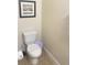 Toilet area features a modern toilet and tile floors at 8189 Roseville Rd, Davenport, FL 33896