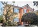 Tan and orange townhouse with brown shutters and landscaping at 871 Assembly Ct, Reunion, FL 34747