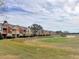 Townhouses near a golf course with lush landscaping at 871 Assembly Ct, Reunion, FL 34747