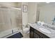 Bathroom with granite countertop, single vanity, and large walk-in shower at 8896 Bengal Ct, Kissimmee, FL 34747