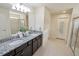 Double vanity bathroom with granite countertop, shower, and separate toilet area at 8896 Bengal Ct, Kissimmee, FL 34747